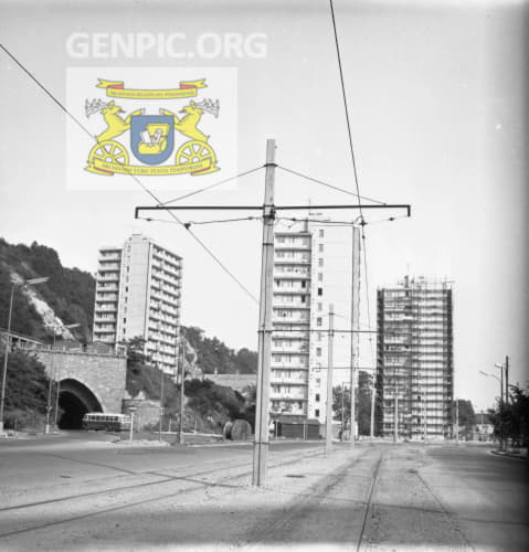 Tram line and apartment buildings. Bratislava public transport bus enters the tunnel.