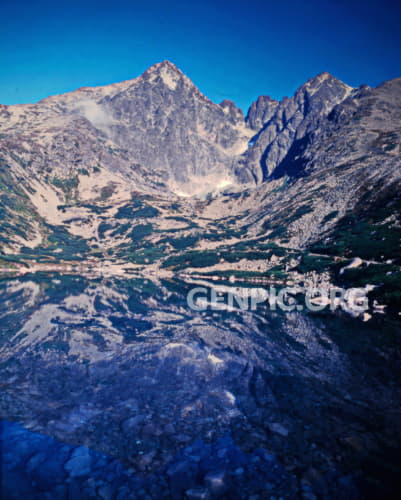 Lomnicky Peak and mountain lake Skalnate pleso.